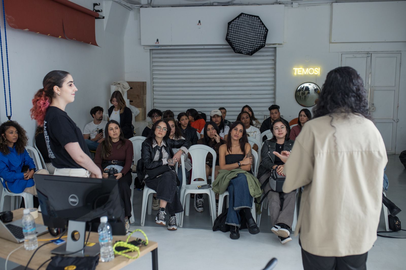 A group of adults listens and participates during an interactive workshop.